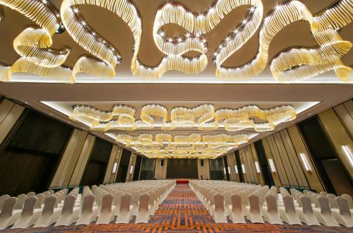 a row of white chairs in a room with chandeliers at Crowne Plaza Chengdu Wuhou by IHG in Chengdu
