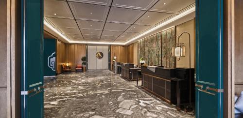 a corridor of a hotel lobby with a hair salon at Crowne Plaza Chengdu Wuhou by IHG in Chengdu