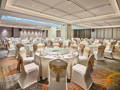a banquet hall with white tables and white chairs at Crowne Plaza Chengdu Wuhou by IHG in Chengdu