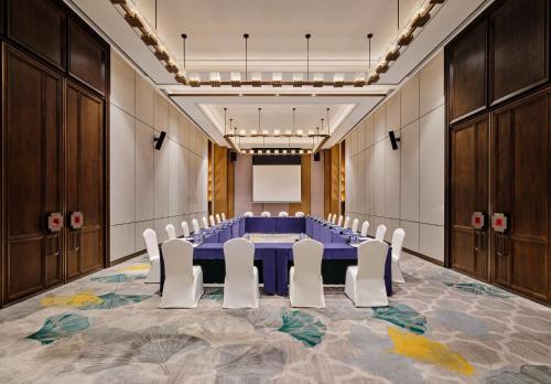 a conference room with a blue table and white chairs at Crowne Plaza Chengdu Wuhou by IHG in Chengdu