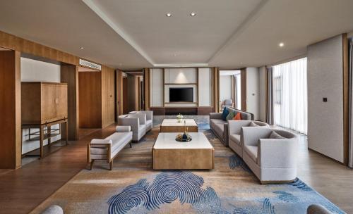 a living room with a couch and a table at Crowne Plaza Chengdu Wuhou by IHG in Chengdu