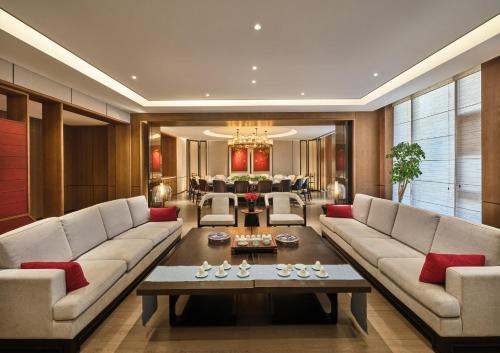 a living room with a couch and a table at Crowne Plaza Chengdu Wuhou by IHG in Chengdu