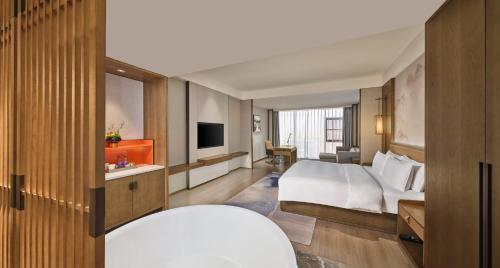a hotel room with a bed and a television at Crowne Plaza Chengdu Wuhou by IHG in Chengdu