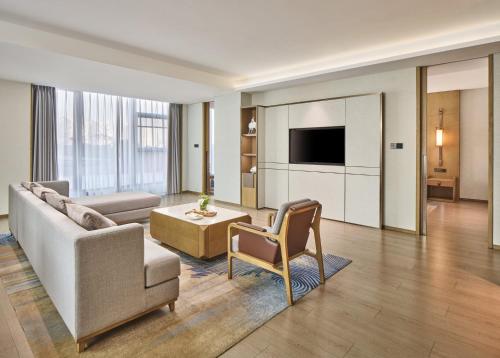 a living room with a couch and a table at Crowne Plaza Chengdu Wuhou by IHG in Chengdu