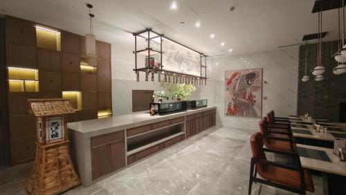 a large kitchen with a counter and a dining room at Crowne Plaza Chengdu Wuhou by IHG in Chengdu