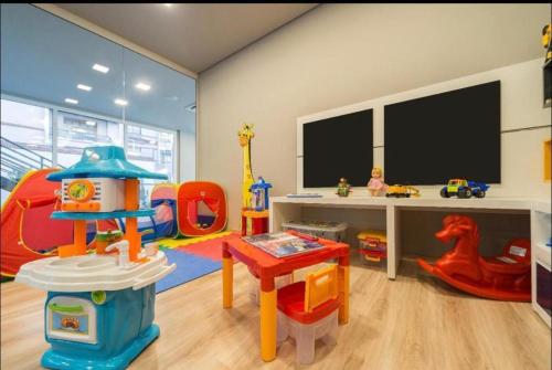 a childs play room with a table and a desk at Laghetto Stilo Borges - Apto 403B in Gramado