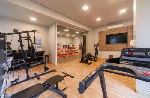 a gym with several exercise equipment in a room at Laghetto Stilo Borges - Apto 403B in Gramado