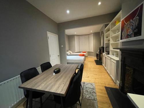 a room with a table and a bed and a bedroom at Home in Greenwich near the O2 in London