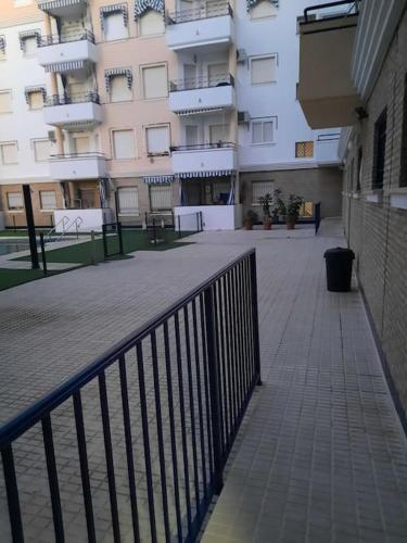 a walkway in front of a large building at Mi bonito apartamento del Portil in El Portil