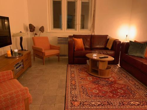 a living room with a couch and a table at Hazmarmar in Csernely