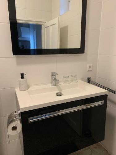 a bathroom with a sink and a mirror at Hazmarmar in Csernely