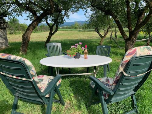 a table and chairs with a bottle of wine on it at Hazmarmar in Csernely