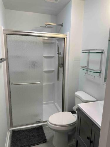 a white bathroom with a shower and a toilet at Chesapeake Holiday House in Port Republic