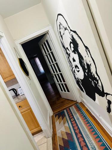 a stairwell with aoyer with a black and white painting at SUNNYside one bedroom apt in Woodside