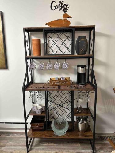 a shelf with a coffee sign on a wall at Chesapeake Holiday House in Port Republic
