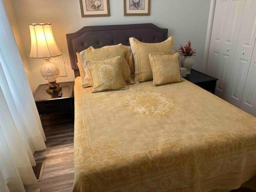 a bedroom with a large bed with a lamp and pillows at Chesapeake Holiday House in Port Republic
