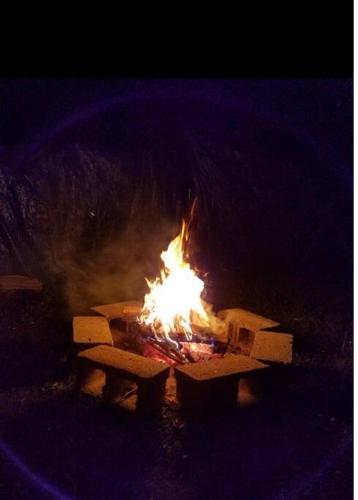 a fire burns in a fire pit at night at Chesapeake Holiday House in Port Republic