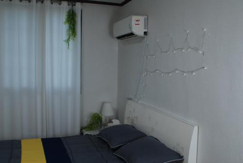 a bedroom with a bed and a white wall at Atti in Pyeongtaek