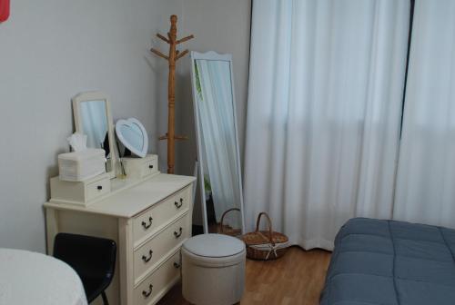 a bedroom with a bed and a dresser with a mirror at Pyeongtaek Tarot 2 House Camp Humphreys 워킹게이트 도보10분 in Pyeongtaek