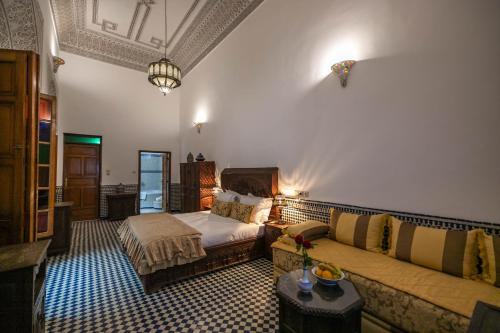 a large room with a bed and a couch at La Perle de La Medina in Fez