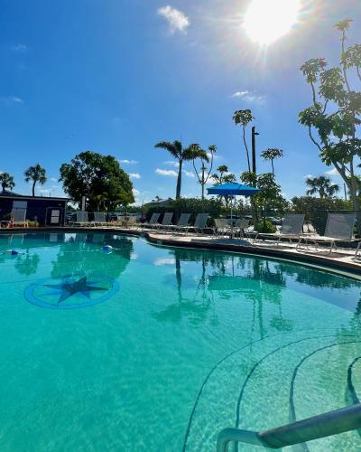 a large swimming pool with blue water at The Suites at Fishermen's Village - 2 Bedroom Suites in Punta Gorda
