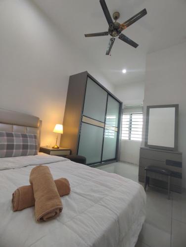 a bedroom with a bed with a towel on it at Ipoh Tambun Sunway next to Heaven Spacious Luxury Home in Kampong Batu Lapan