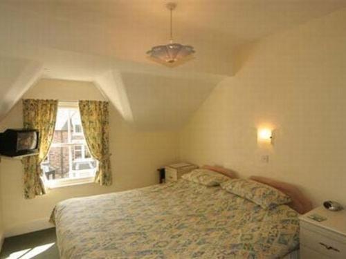 a bedroom with a bed and a window at Silverdale Guesthouse in Keswick