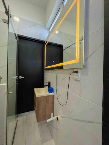 a bathroom with a sink and a mirror at Rio-ApartaHotel-Lagos in Leticia