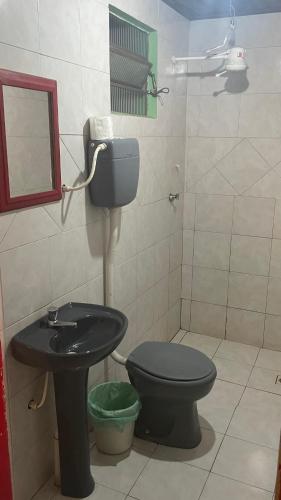uma casa de banho com um WC e um lavatório em Motel Casarão em Osório