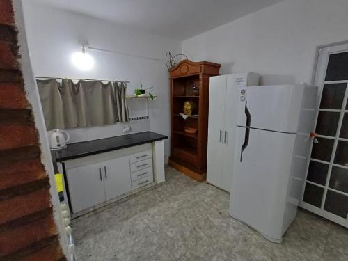 a kitchen with a white refrigerator and a counter at Dpto Lu 2 in Villa Mercedes