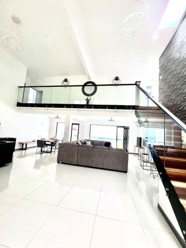 a large living room with a couch and a table at Oceanview lux Villa + Infinity pool, Chef & Butler in Kings Pen