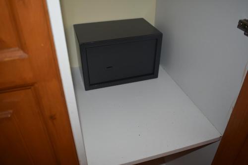 a small television sitting on a shelf in a room at Hector's Studios in Alikanas