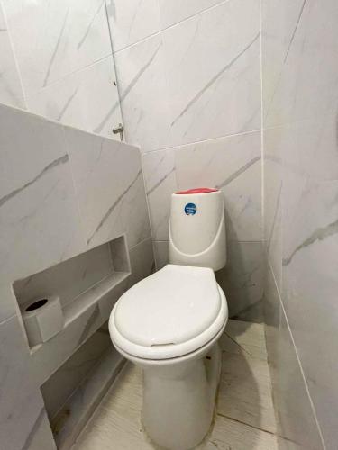 a bathroom with a white toilet in a stall at Rio-ApartaHotel-Lagos in Leticia