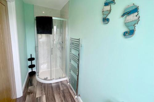 a bathroom with a shower with a glass door at An Lochan in Manish