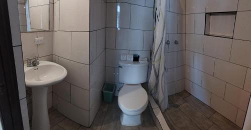 a bathroom with a toilet and a sink at Hotel Sevilla in Guatemala