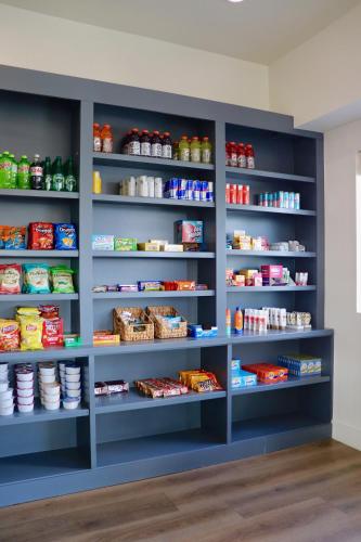 a pantry with blue shelves filled with food at The Suites at Fishermen's Village - 2 Bedroom Suites in Punta Gorda