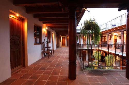 a corridor of a building with a walkway at Hotel Candelaria Antigua in Antigua Guatemala