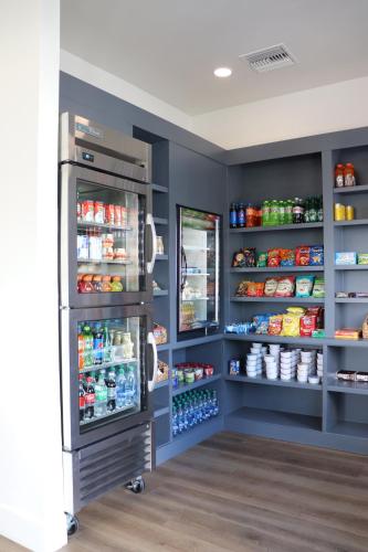 a pantry with a refrigerator and lots of food at The Suites at Fishermen's Village - 2 Bedroom Suites in Punta Gorda