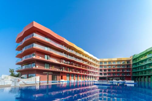 a building with a pool in front of it at voco Dubai Monaco, the Heart of Europe by IHG in Dubai