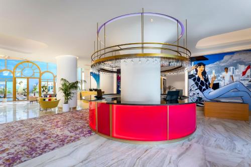 a large room with a red island in the middle at voco Dubai Monaco, the Heart of Europe by IHG in Dubai