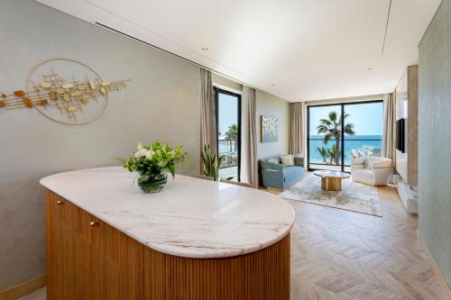 a kitchen with a island with a vase of flowers at voco Dubai Monaco, the Heart of Europe by IHG in Dubai