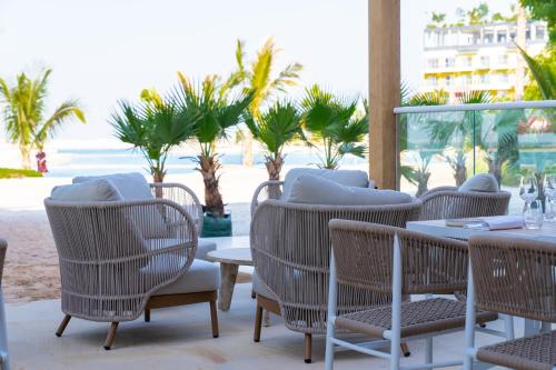 a restaurant with chairs and tables on the beach at voco Dubai Monaco, the Heart of Europe by IHG in Dubai