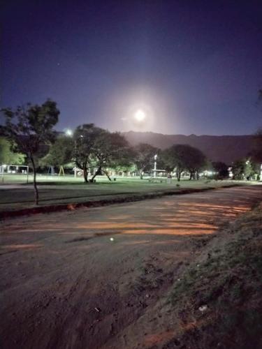 uma rua vazia à noite num parque com árvores em Alojamiento por día Merlo San Luis em Merlo