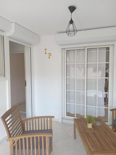 a living room with a table and a chair at L'INSTANT PRESENT in Le Moule