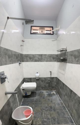 a bathroom with a toilet and a sink at Lee home stay in Hampi