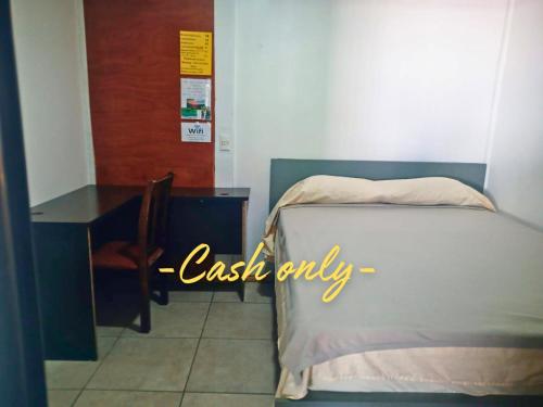 a bedroom with a desk and a bed and a table at Hogar tico-estadounidense cerca de aeropuerto in Alajuela City
