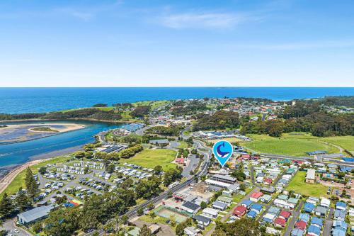 an aerial view of a city next to the ocean at Narooma Lighthouse Cottage - 74 Princes Highway Narooma in Narooma