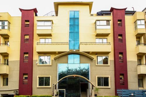 an apartment building with glass windows at OYO 6825 New Crescent Citadel in Bangalore