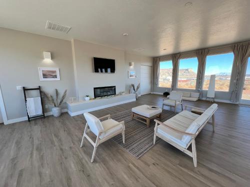 a living room with white furniture and a fireplace at Page Arizona border town- Tranquil Zen Retreat with Amazing Mesa Views in Big Water