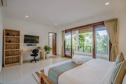 a bedroom with a large bed and a large window at 5 Bedroom Villa in Centre Location of Seminyak in Seminyak